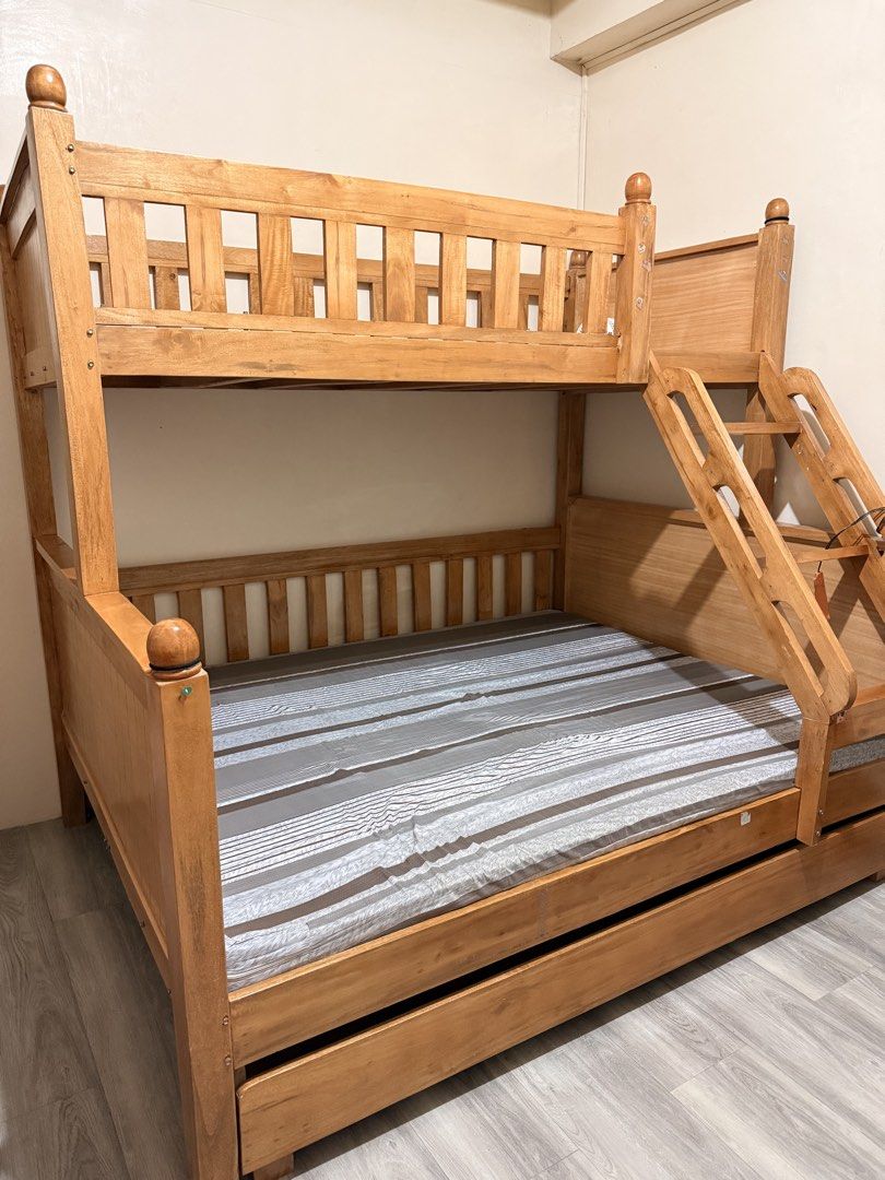 Solid Wood Bunk Bed with Trundle (Category: Bed Frames & Mattresses) located in Manila. Submitted by ichbinschtella (Listing ID 1440339781, Image 1). Description: - Solid wood bunk bed - Includes pull-out trundle - Top bunk with safety rails - Side-attached ladder - Bottom foam included - Sturdy construction - Ideal for saving bedroom space - Ready for a new home .
