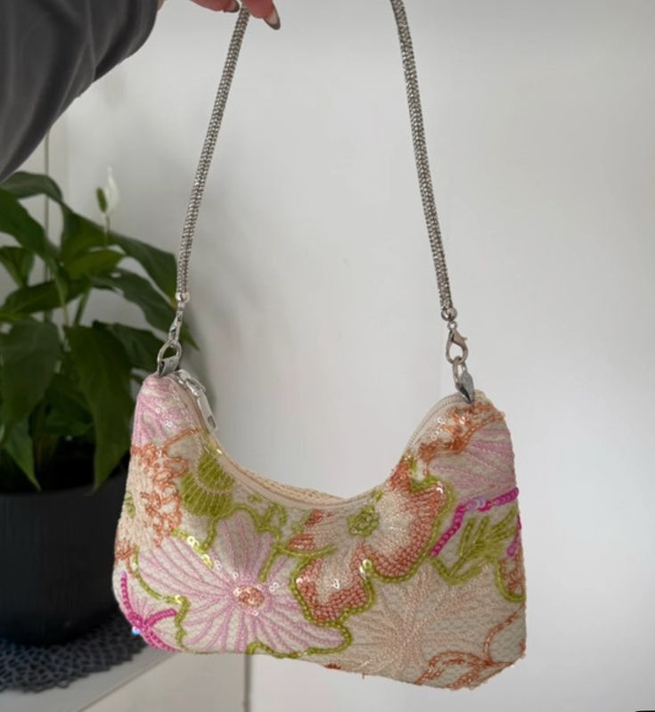 Sparkly Floral Shoulder Bag with Chain Strap (Category: Shoulder Bags) located in Panabo. Submitted by strewbardi (Listing ID 1440342859, Image 3). Description: - message for more detailed and actual pics -Cute shoulder bag with a beautiful floral design. - Covered in shimmering sequins and beads for a dazzling look. - Features a stylish silver chain strap. - Ideal for parties, nights out, or any special occasion. - Zipper closure keeps your belo