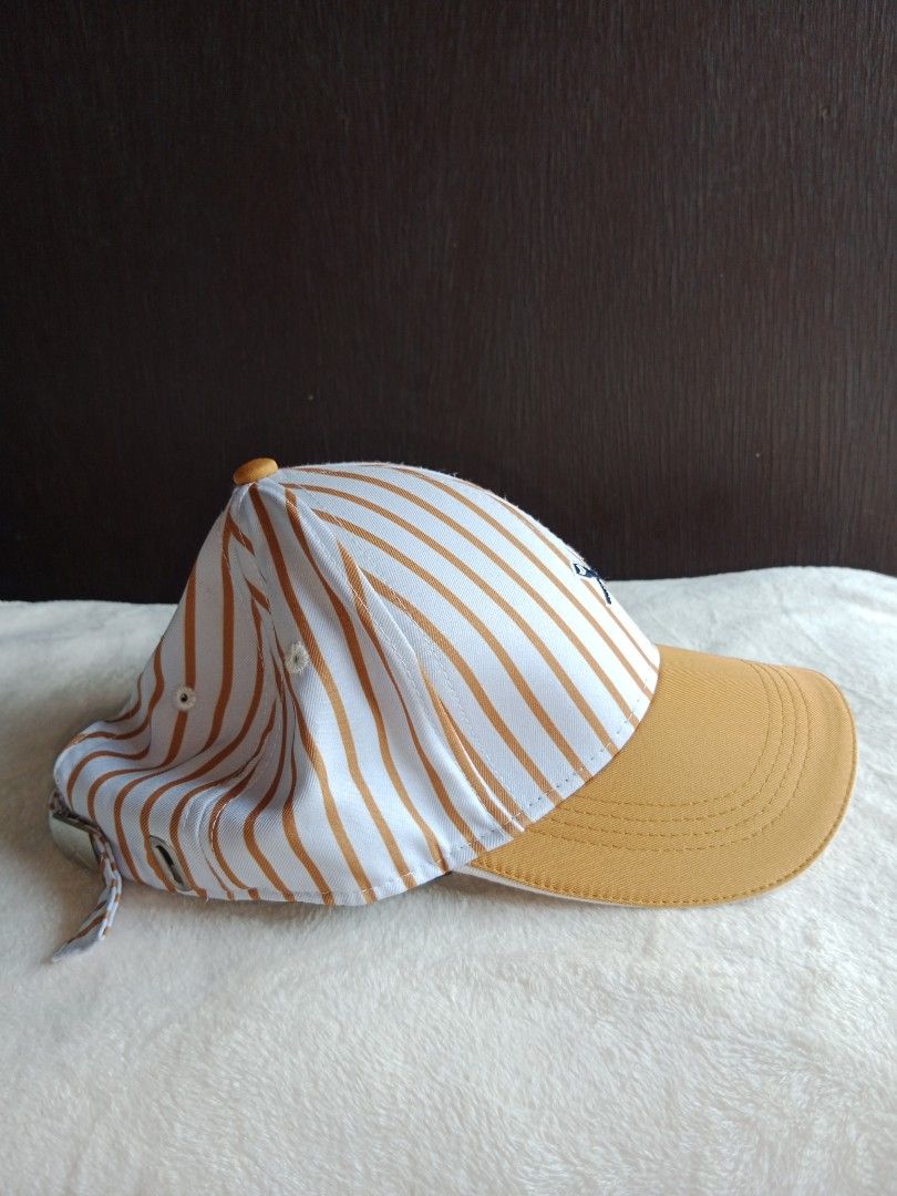 Striped Baseball Cap with Logo (Category: Caps & Hats) located in Manila. Submitted by angeloarce64172 (Listing ID 1440238556, Image 3). Description: declutter mode. kesa nasa drawer lang.. ibenta na lang. p250. di naman nagamit. brand new. salamat po. original po. - Classic navy blue baseball Stylish baseball cap featuring a white and orange vertical stripe pattern. The brim is a solid orange color. It has a small embroidered logo on the front a