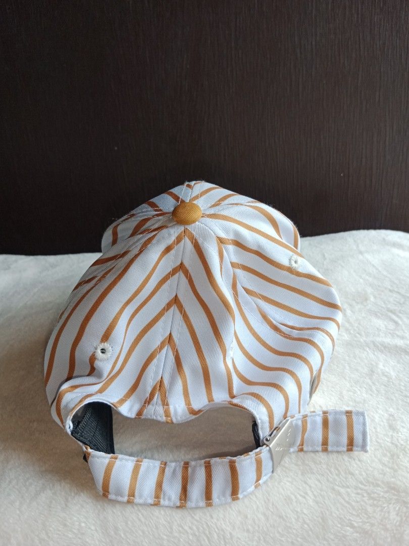 Striped Baseball Cap with Logo (Category: Caps & Hats) located in Manila. Submitted by angeloarce64172 (Listing ID 1440238556, Image 2). Description: declutter mode. kesa nasa drawer lang.. ibenta na lang. p250. di naman nagamit. brand new. salamat po. original po. - Classic navy blue baseball Stylish baseball cap featuring a white and orange vertical stripe pattern. The brim is a solid orange color. It has a small embroidered logo on the front a