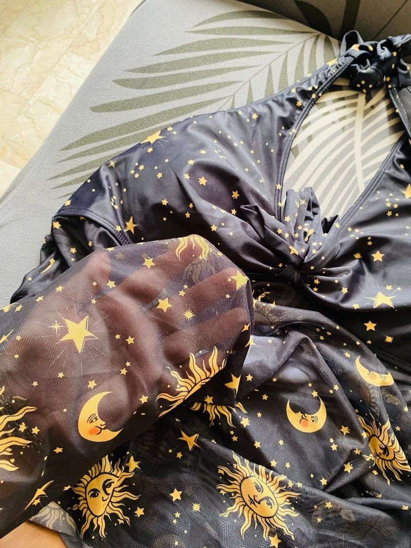 Swimsuit 3xl to 5xl (Category: Bikinis & Swimsuits) located in Cainta. Submitted by sjprelovedbotique (Listing ID 1440381397, Image 3). Description: Black halter cover-up with celestial print (suns, moons, stars in gold). Sheer mesh skirt. Ties at neck and back. Perfect for beach or pool..