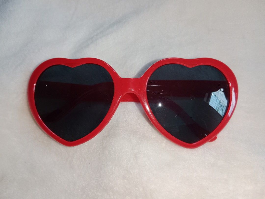 Taylor Swift 22 Heart Shaped Sunglasses (Category: Sunglasses & Eyewear) located in Manila. Submitted by angeloarce64172 (Listing ID 1440378845, Image 1). Description: - Fun red heart-shaped sunglasses - Dark lenses for effective sun protection - Ideal for parties, festivals, or everyday fun - Lightweight and comfortable plastic frame - A playful accessory to elevate any outfit.