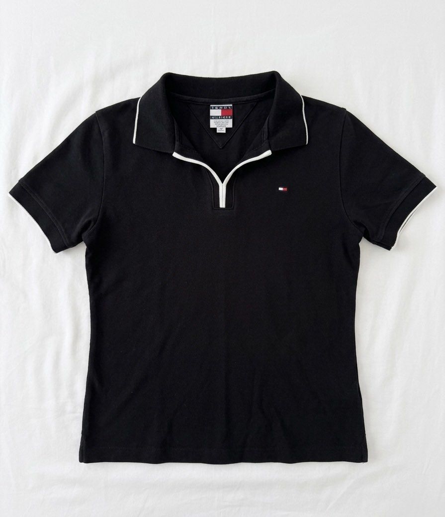 Tommy Hilfiger Black Polo Shirt (Category: Shirts) located in Cabanatuan. Submitted by scrlttt (Listing ID 1440290370, Image 1). Description: - Classic black Tommy Hilfiger polo shirt - Quarter-zip neckline with white trim - Small Tommy Hilfiger flag logo on the chest - Short sleeves with white trim on cuffs - Ideal for casual wear.