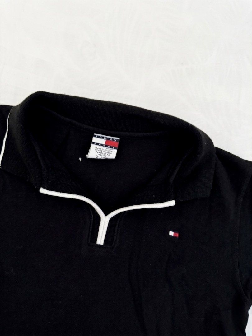 Tommy Hilfiger Black Polo Shirt (Category: Shirts) located in Cabanatuan. Submitted by scrlttt (Listing ID 1440290370, Image 2). Description: - Classic black Tommy Hilfiger polo shirt - Quarter-zip neckline with white trim - Small Tommy Hilfiger flag logo on the chest - Short sleeves with white trim on cuffs - Ideal for casual wear.