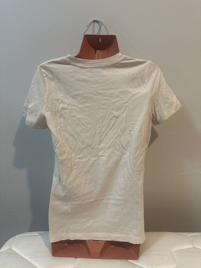 Tommy Hilfiger T-shirt (Category: Shirts) located in Las Pinas. Submitted by Mkdot (Listing ID 1439831762, Image 2). Description: - Cream-colored Tommy Hilfiger T-shirt - Crew neck - Navy blue Tommy Hilfiger logo on chest - Short sleeves - Plain back - Lightweight fabric - Perfect for everyday wear - A versatile wardrobe staple.