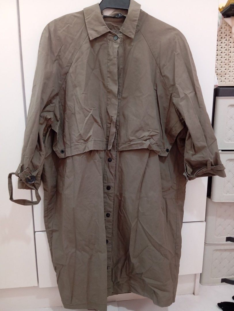 Unbranded Khaki Long Trench Coat (Category: Coats, Jackets and Outerwear) located in Manila. Submitted by brion123 (Listing ID 1440226532, Image 2). Description: - Stylish khaki long trench coat - Classic collar and button-down front - Adjustable cuffs with button tabs - Unique layered design across the chest - Ideal for layering over outfits for a chic look.