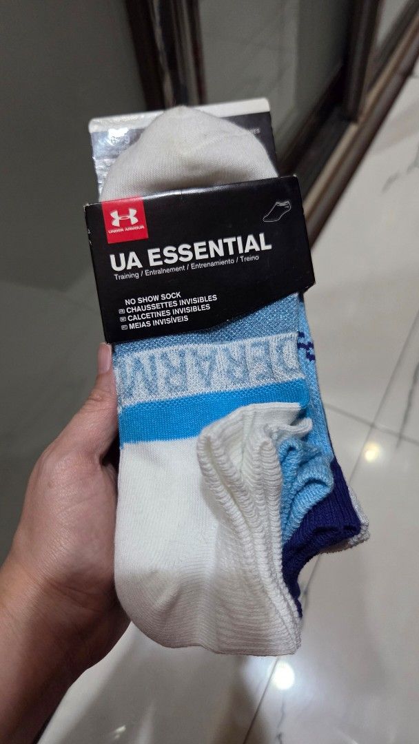 Under Armour UA Essential No Show Socks (Category: Socks) located in Quezon City. Submitted by liquidatormnl (Listing ID 1440342051, Image 1). Description: brand new Brand: Under Armour (UA) - Style: Essential No-Show Socks - Color: White with blue and light blue accents - Ideal for: Everyday wear - Packaging: Comes in a pack - Condition: New bought in states.