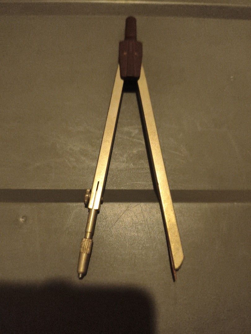 Vintage Brass Drawing Compass Tool (Category: Stationery & School Supplies) located in Manila. Submitted by joe.kelly (Listing ID 1440344850, Image 1). Description: - Rotring drawing compass - Features a dark brown handle - Easily adjusts for different circle sizes - Ideal for drafting, art, and technical drawing Location : Petron Commonwealth beside Toyota Commonwealth.