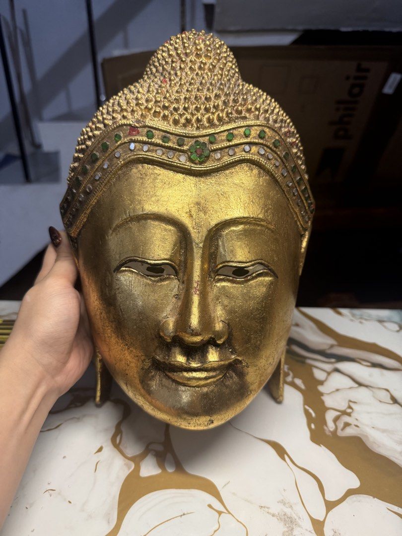 Vintage Golden Buddha Head Wall Decor (Category: Other Home Decor) located in Makati City. Submitted by annelipse0003 (Listing ID 1440352768, Image 1). Description: - Stunning golden Buddha head statue - Approximately 35cm in height - Exquisite crown detailing with vibrant, colorful stones - Ideal for enhancing your home decor or spiritual sanctuary - A truly unique and eye-catching piece.