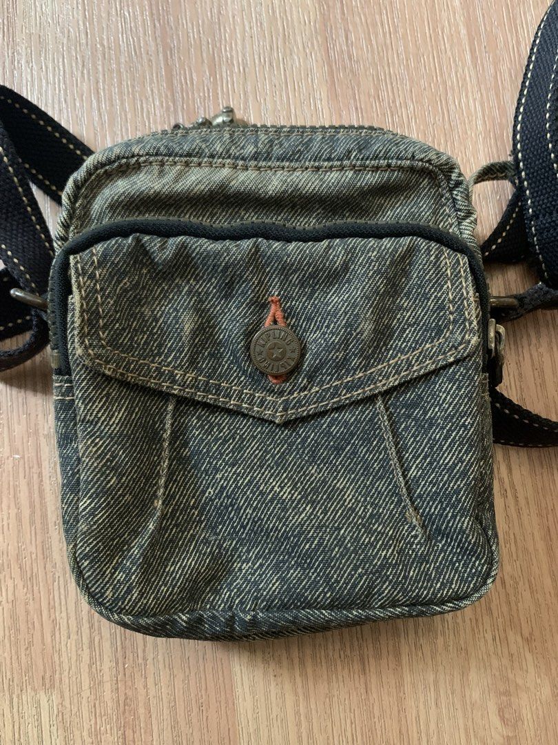 Vintage Kipling Denim Mini Crossbody Bag with Monkey Charm (Category: Cross-body Bags) located in Manila. Submitted by riki_won09 (Listing ID 1440234524, Image 1). Description: - Cute Kipling crossbody bag - Washed-out denim material - Front pocket with button closure and chain detail - Interior with striped lining and zippered pocket - Adjustable strap for comfortable wear - Ideal for everyday use and fashion.