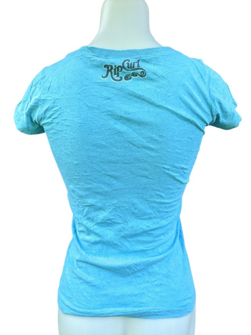 Vintage Rip Curl Blue Graphic T-shirt Palm Tree Design Size 6 (Category: Shirts) located in Kapalong. Submitted by hashhthrift (Listing ID 1440211423, Image 2). Description: no issue color rate 9.9/10 excellent condition complete tags measurements: length 23 width 14.