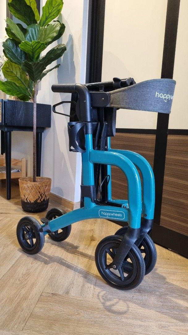 Walker (Category: Other Assistive Aids) located in Singapore. Submitted by oned17 (Listing ID 1440287659, Image 3). Description: - HappyWheels walker in teal - Built-in seat - Comes with storage bag - Adjustable handle height - Folds easily for simple transport and storage - Ideal for mobility assistance - Well used but not abused. See photos - RFS bought new model - Retailing at $232.