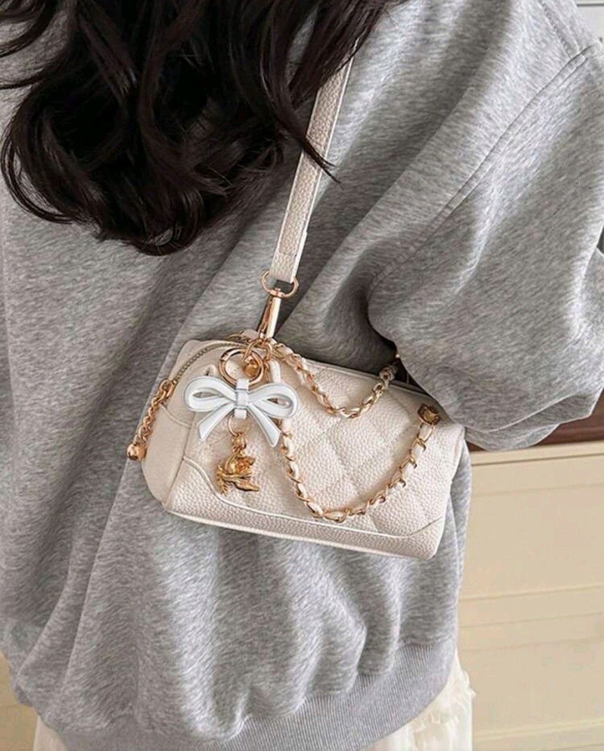 White Quilted Mini Barrel Bag with Bow Charm (Category: Luxury Bags & Wallets) located in Quezon City. Submitted by twinkle97 (Listing ID 1440268753, Image 2). Description: - Adorable white mini barrel bag - Stylish quilted texture all over - Includes a chic gold chain strap - Comes with a cute bow charm with gold accent - Versatile: can be worn as a crossbody or shoulder bag - Perfect size for carrying your essentials - Great for going out and s