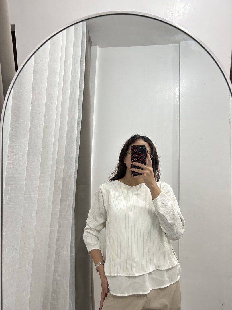 White Striped Long Sleeve Top with Layered Hem (Category: Longsleeves) located in Caloocan City. Submitted by avryph (Listing ID 1440367069, Image 1). Description: - White top with subtle vertical pinstripes - Long sleeves - Unique layered hem detail for a distinctive silhouette - Easily pairs with trousers or skirts - Perfect for both casual and dressed-up occasions.