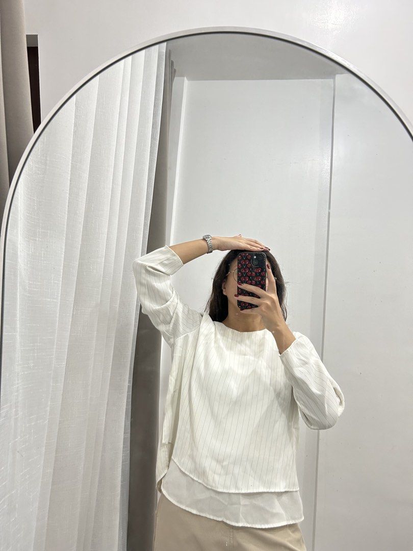 White Striped Long Sleeve Top with Layered Hem (Category: Longsleeves) located in Caloocan City. Submitted by avryph (Listing ID 1440367069, Image 2). Description: - White top with subtle vertical pinstripes - Long sleeves - Unique layered hem detail for a distinctive silhouette - Easily pairs with trousers or skirts - Perfect for both casual and dressed-up occasions.
