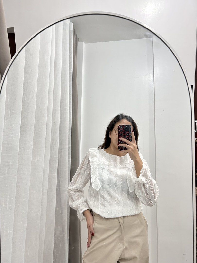 White Textured Ruffle Long Sleeve Blouse (Category: Blouses) located in Caloocan City. Submitted by avryph (Listing ID 1440367160, Image 1). Description: - Cute white blouse - Textured fabric - Ruffles down the front - Long sleeves with ruffled cuffs - Pairs well with trousers or skirts - Perfect for dressing up or down - Comfortable and stylish.