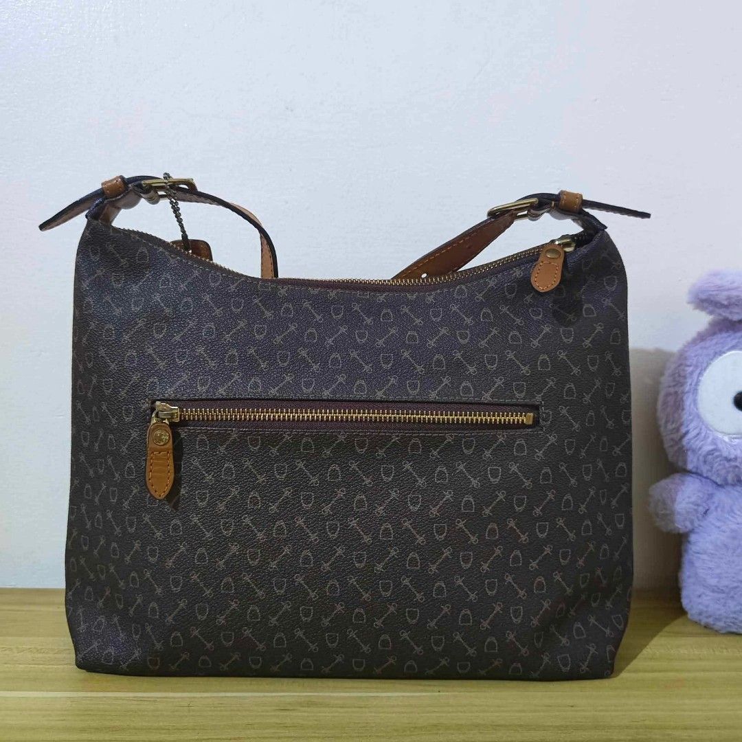 Why Harness (Japan) Monogram Hobo / Shoulder Bag (Category: Shoulder Bags) located in San Pedro. Submitted by riavskz (Listing ID 1440271148, Image 2). Description: 👜 Why Harness (Japan) Monogram Hobo / Shoulder Bag • Japan/Korea sourced preloved bag • Coated canvas / PVC body with all-over monogram print (keys and shield / harness motif) • Dark brown base with tan / cognac genuine leather handles, trim, and hang tag • Crescent / hobo shoulder s