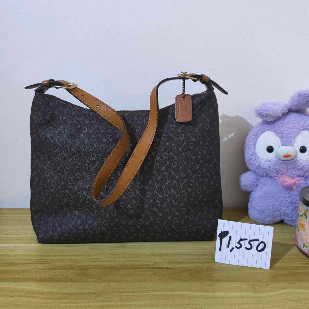 Why Harness (Japan) Monogram Hobo / Shoulder Bag (Category: Shoulder Bags) located in San Pedro. Submitted by riavskz (Listing ID 1440271148, Image 1). Description: 👜 Why Harness (Japan) Monogram Hobo / Shoulder Bag • Japan/Korea sourced preloved bag • Coated canvas / PVC body with all-over monogram print (keys and shield / harness motif) • Dark brown base with tan / cognac genuine leather handles, trim, and hang tag • Crescent / hobo shoulder s
