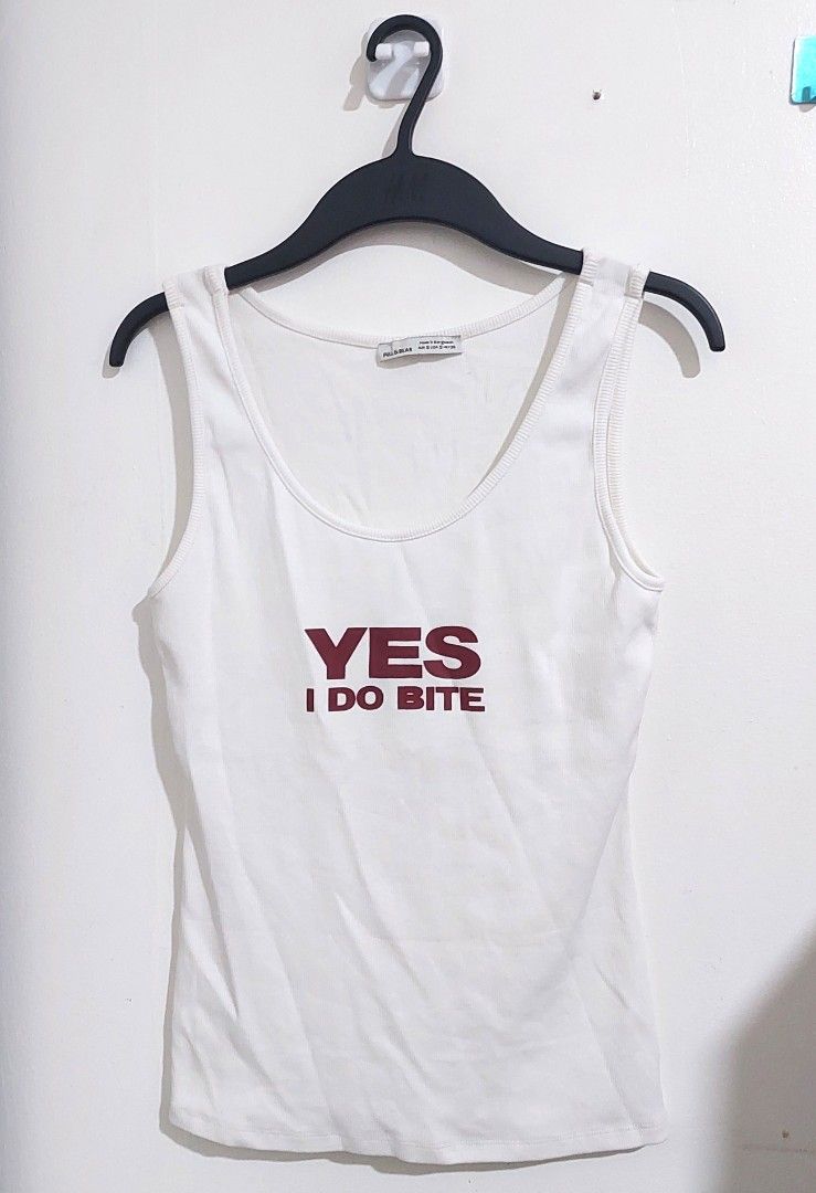 Y2k "YES, I do bite" printed sleeveless top with snap button straps (Category: Sleeveless) located in Pasay City. Submitted by pompompie (Listing ID 1440237536, Image 1). Description: Brand new and unused, without hangtag. No issues. Thick cotton comfortable sleeveless tee, perfect for the summer heat. No when worn photos, no measuring tools. Use size below as basis. Size: S on tag, fits S-M (stretchy material) TAGS: cottagecore, softgirl, softco