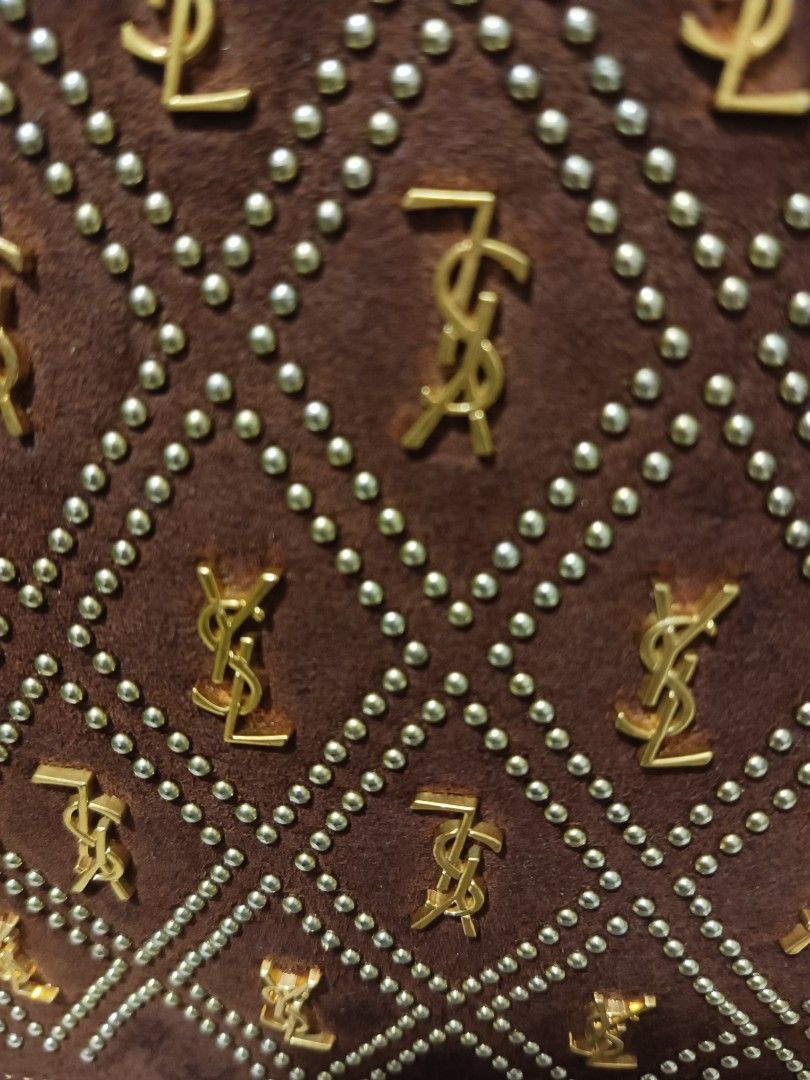 Yves Saint Laurent YSL Monogram Shoulder Bag (Category: Luxury Bags & Wallets) located in Digos. Submitted by chihanu (Listing ID 1440334840, Image 2). Description: - Brown suede shoulder bag - Features iconic gold YSL monograms - Adorned with gold stud details - Elegant diamond pattern throughout - Stylish gold chain strap - Ideal for evening events or as a statement piece.