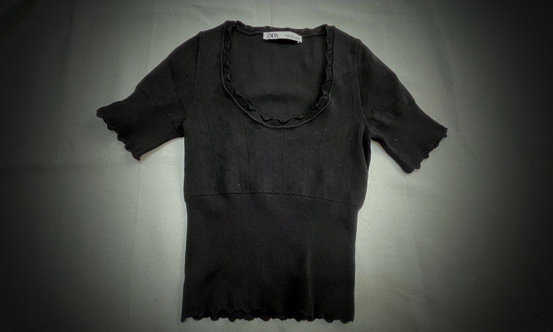 Zara Black Ribbed Lettuce Hem Top (Category: Shirts) located in Pasig City. Submitted by ___she___ (Listing ID 1440284465, Image 1). Description: - Black Zara top - Short sleeves with lettuce hem - Ribbed texture - Scoop neckline with lettuce trim - Fitted silhouette - Ideal for layering or wearing solo.