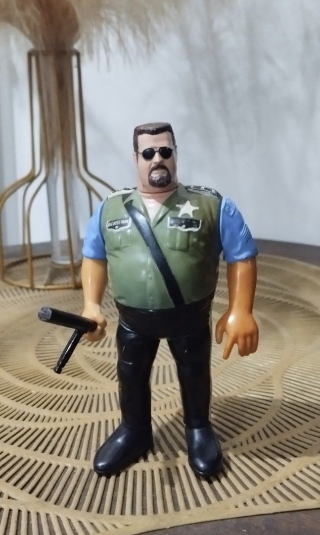 1990 WWF Hasbro Big Boss Man action figure (Category: Action & Battle Toys) located in Manila. Submitted by ventajetoyz625 (Listing ID 1439357325, Image 2). Description: - Vintage action figure - Features a man with sunglasses - Green vest and black pants - Blue shirt - Collectible item - With minimal chipped paint - What you see is what you get.
