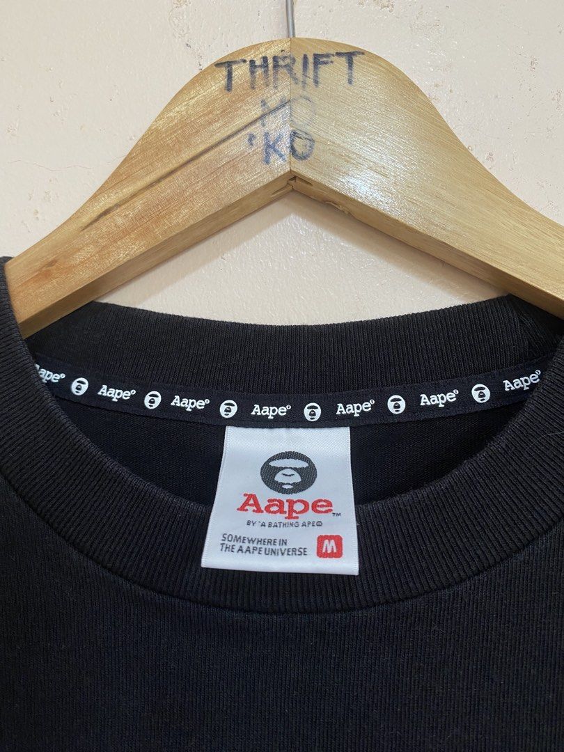 Aape By A Bathing Ape Graphic T-Shirt (Category: Tshirts & Polo Shirts ) located in Santiago. Submitted by mfdthriftstore (Listing ID 1440457435, Image 2). Description: - Black Aape T-shirt - Cool graphic print - Size: Medium (fits Medium to Large) - Ideal for casual wear.