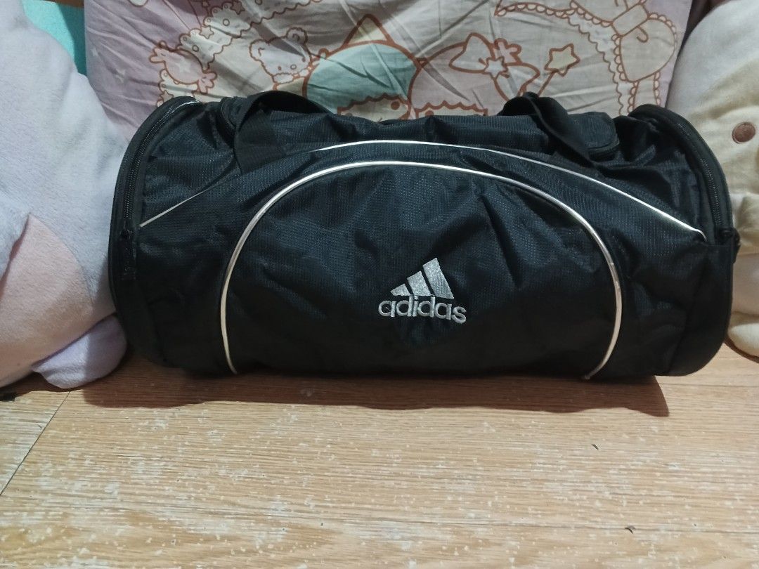 Adidas Black Duffel Bag (Category: Backpacks) located in Rizal. Submitted by a.s.r (Listing ID 1440527966, Image 1). Description: - Classic black Adidas duffel bag - Secure zipper closure - Stylish silver trim accents on the front - Ideal for gym sessions or weekend getaways - Spacious interior for all your essentials.