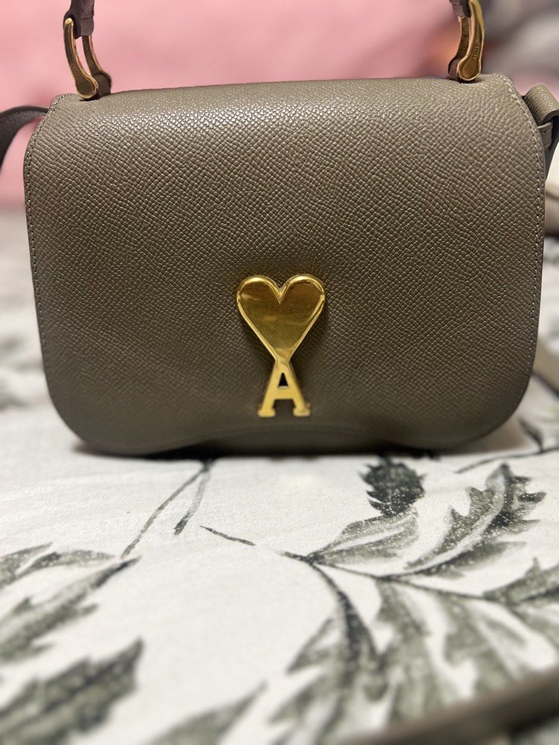 AMI Paris Ami de Coeur Small Bag (Category: Luxury Bags & Wallets) located in Manila. Submitted by aliyahkennedy (Listing ID 1440520964, Image 2). Description: - AMI Paris bag in olive green - Iconic gold Ami de Coeur logo hardware - Adjustable strap for versatile crossbody or shoulder wear - Compact size, perfect for essentials.