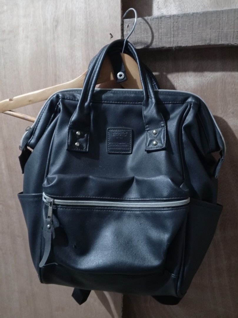Anello Black/White Faux Leather Backpack (Category: Backpacks) located in Las Pinas. Submitted by biyaya_ (Listing ID 1440546305, Image 2). Description: - Black Anello-style backpack - Made from durable faux leather - Zippered front pocket for quick access - Convenient side pockets - Comfortable top handles and adjustable shoulder straps - Ample interior space for all your essentials - Ideal for everyday commutes or weekend getaways.