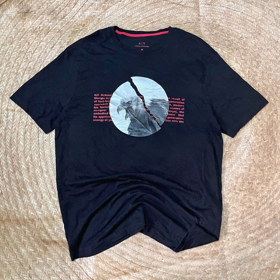 Armani Exchange Black Eagle Graphic T-Shirt Size M (Category: Tshirts & Polo Shirts ) located in Cabadbaran. Submitted by reylandx (Listing ID 1440477688, Image 1). Description: - Dimes: 21x28 - Color rate: 9.8/10 - No issue - Armani Exchange T-Shirt - Size: Medium (M) - Design: Cool graphic print with eagle and text - Origin: Made in Cambodia - Style: Ideal for casual wear - Condition: Please check photos for detailed condition.