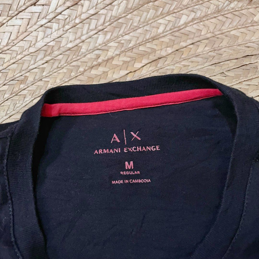 Armani Exchange Black Eagle Graphic T-Shirt Size M (Category: Tshirts & Polo Shirts ) located in Cabadbaran. Submitted by reylandx (Listing ID 1440477688, Image 2). Description: - Dimes: 21x28 - Color rate: 9.8/10 - No issue - Armani Exchange T-Shirt - Size: Medium (M) - Design: Cool graphic print with eagle and text - Origin: Made in Cambodia - Style: Ideal for casual wear - Condition: Please check photos for detailed condition.