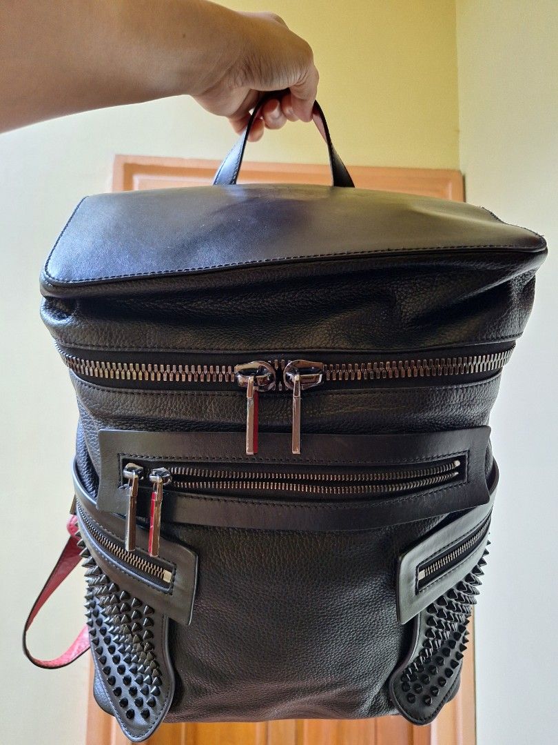 Authentic Christian Louboutin Spiked Leather Backpack (Category: Backpacks) located in Taguig. Submitted by 1stdibs (Listing ID 1440414490, Image 2). Description: pre owned, authentuc Christial louboutin spiked Red backpack shows sign of wear and usage.