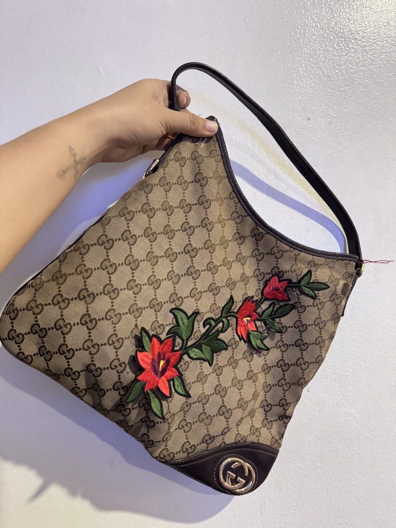 Authentic Gucci Monogram Shoulder Bag with Floral Embroidery (Category: Luxury Bags & Wallets) located in Manila. Submitted by thriftyhaven2023 (Listing ID 1440529213, Image 1). Description: Has flaws on canvas as seen on pictures. And in leather part handle. Hence the bag is still functional and selling low. Pwede maging project bag. GUARANTEED AUTHENTIC. - Authentic Gucci shoulder bag - Classic GG monogram canvas - Beautiful red floral embroide