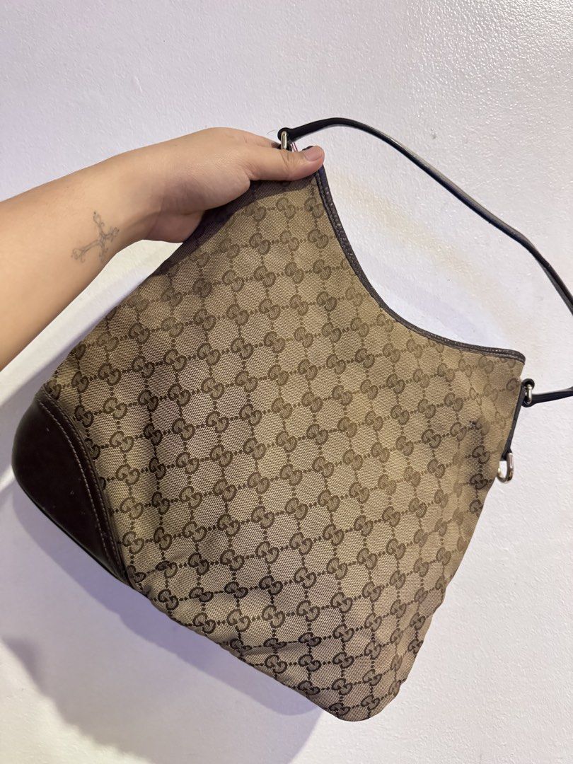 Authentic Gucci Monogram Shoulder Bag with Floral Embroidery (Category: Luxury Bags & Wallets) located in Manila. Submitted by thriftyhaven2023 (Listing ID 1440529213, Image 2). Description: Has flaws on canvas as seen on pictures. And in leather part handle. Hence the bag is still functional and selling low. Pwede maging project bag. GUARANTEED AUTHENTIC. - Authentic Gucci shoulder bag - Classic GG monogram canvas - Beautiful red floral embroide