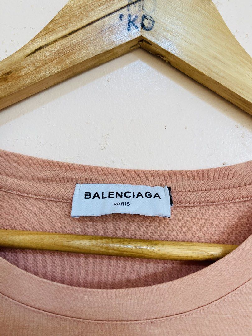 Balenciaga Logo T-Shirt (Category: Tshirts & Polo Shirts ) located in Santiago. Submitted by mfdthriftstore (Listing ID 1440458897, Image 2). Description: - Balenciaga Paris T-shirt - Size: Large - Color: Peachy Pink - Material: 95% Cotton, 5% Spandex - Condition: Excellent, no issues - Care instructions available on tag.