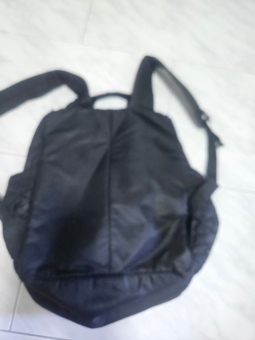 Black Backpack (Category: Cross-body Bags) located in Singapore. Submitted by andersonn26811 (Listing ID 1440468422, Image 1). Description: - Black backpack - Made of nylon material - Adjustable straps - Main compartment with additional smaller pockets - Suitable for everyday use or travel - Clean and functional condition.