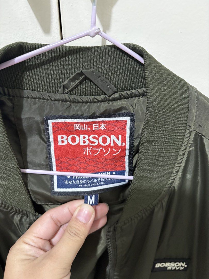 Bobson Olive Green Bomber Jacket Size M (Category: Coats, Jackets and Outerwear) located in Pasig City. Submitted by grumpycat15 (Listing ID 1440493376, Image 2). Description: - Bobson Olive Green Bomber Jacket - Made in Japan - Size: Medium (M) - Classic bomber style with ribbed cuffs and hem - Lightweight material, ideal for layering - Perfect for casual wear - Please check photos for detailed condition.