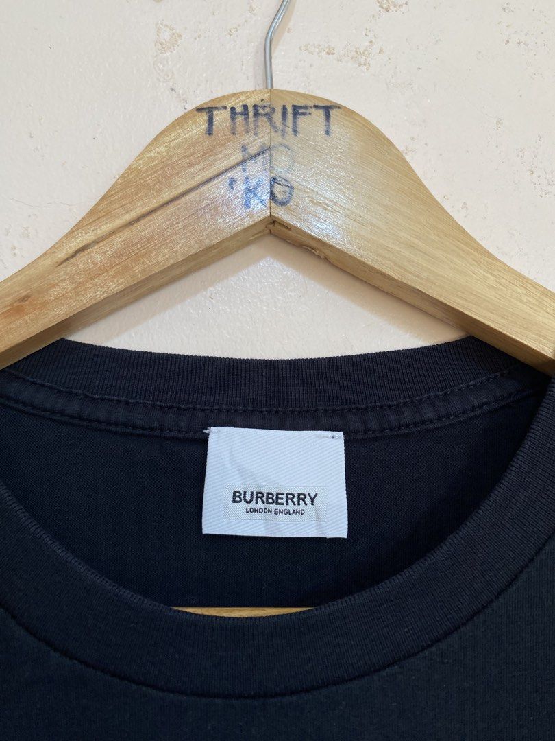 Burberry Black Monogram Logo T-Shirt (Category: Tshirts & Polo Shirts ) located in Santiago. Submitted by mfdthriftstore (Listing ID 1440458457, Image 2). Description: - Authentic Burberry Black T-shirt - Iconic TB monogram logo on chest - Size: Small - Made in Portugal - Material: 98% Cotton, 2% Elastane - Condition: Excellent, good as new, no issues.