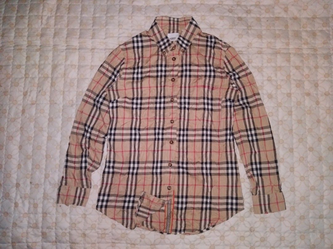 Burberry Nova Check Button down longsleeve women (Category: Coats, Jackets and Outerwear) located in Zamboanga. Submitted by zhumhazhav (Listing ID 1440577045, Image 1). Description: - Classic Burberry longsleeve Polo Shirt - Iconic Burberry checkered pattern throughout - Button down style with collared neckline - Buttoned cuffs - Features check pattern on pockets & cuffs - Excellent condition to as new - Size38 on tag - Dimensions Width 18 Lengt