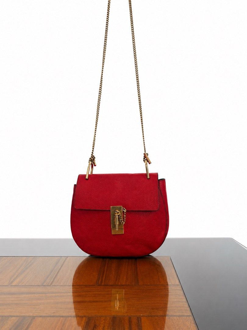 Chloe Chain Crossbody Bag (Category: Luxury Bags & Wallets) located in Paranaque City. Submitted by katlouieleandicho (Listing ID 1440402142, Image 1). Description: 💯Authentic Elegant red leather crossbody/shoulder bag with gold chain strap and luxe gold hardware. Features a structured silhouette with a chic flap closure — perfect for elevating both casual and dressy outfits. In very good condition, hardware closure shows slight tarnishing.