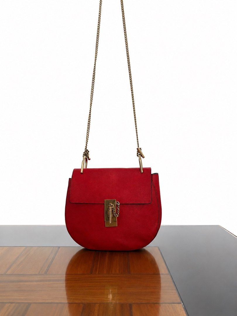 Chloe Chain Crossbody Bag (Category: Luxury Bags & Wallets) located in Paranaque City. Submitted by katlouieleandicho (Listing ID 1440402142, Image 2). Description: 💯Authentic Elegant red leather crossbody/shoulder bag with gold chain strap and luxe gold hardware. Features a structured silhouette with a chic flap closure — perfect for elevating both casual and dressy outfits. In very good condition, hardware closure shows slight tarnishing.