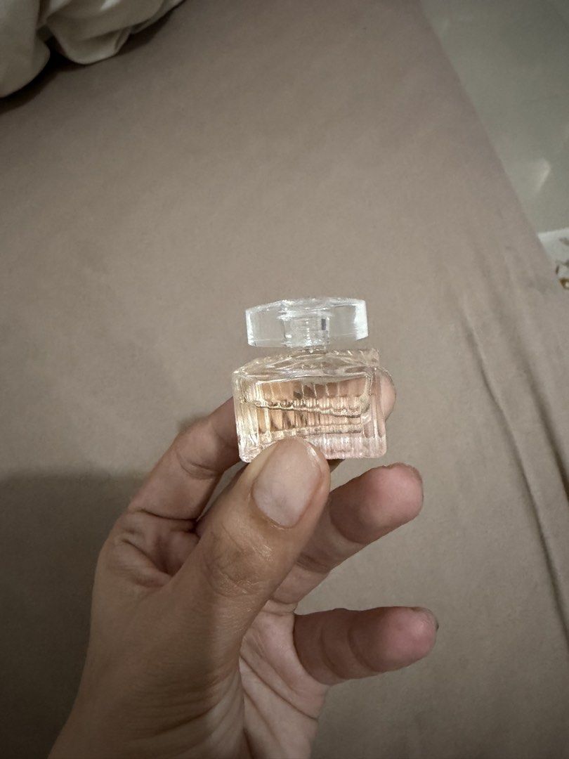 Chloe Miniature Perfume Bottle - Clear Glass (Category: Fragrance & Deodorants) located in Davao. Submitted by fabdeclutter (Listing ID 1440566914, Image 1). Description: - Tiny clear glass perfume bottle - Features a faceted cap - Ideal sample size for collections or travel - Contains a light peachy colored liquid - Bottle has textured sides.