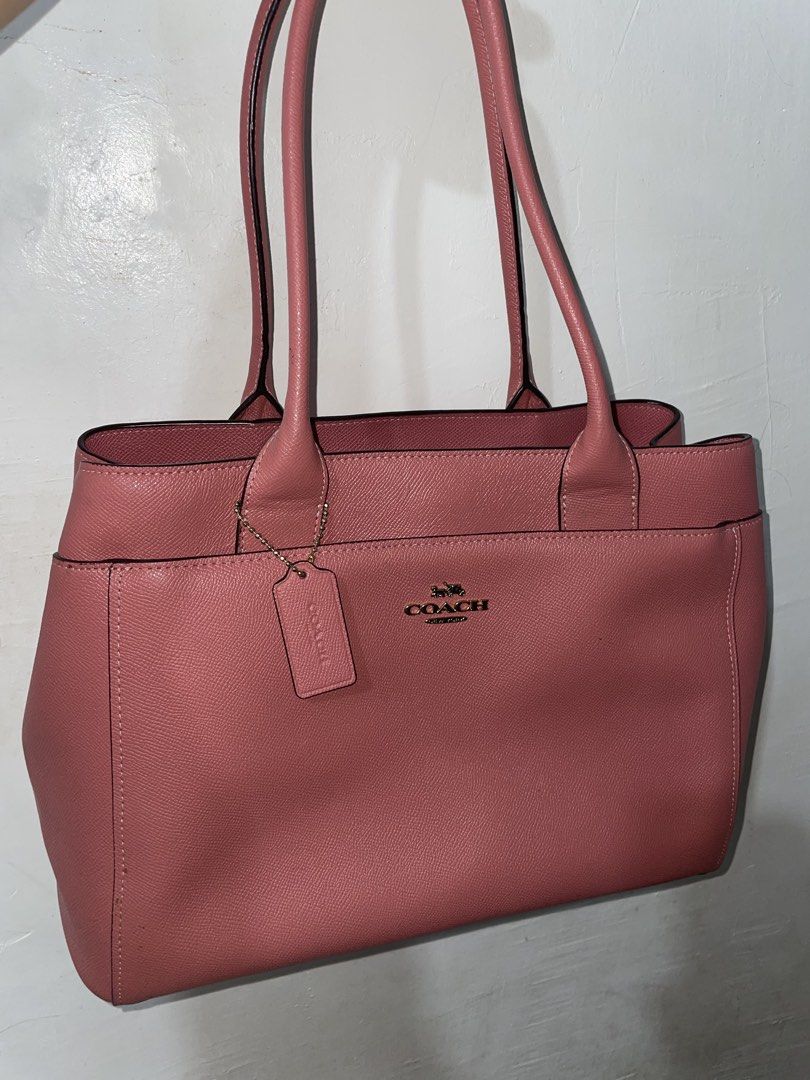 Coach Casey Crossgrain Pink Leather Bag (Category: Luxury Bags & Wallets) located in Manila. Submitted by earlonashow (Listing ID 1440427826, Image 1). Description: - Lovely pink Coach tote bag - Made with textured leather - Main zippered compartment - Interior pockets for organization - Four protective metal feet on the bottom - Interior lining shows some wear - Ideal for everyday use.