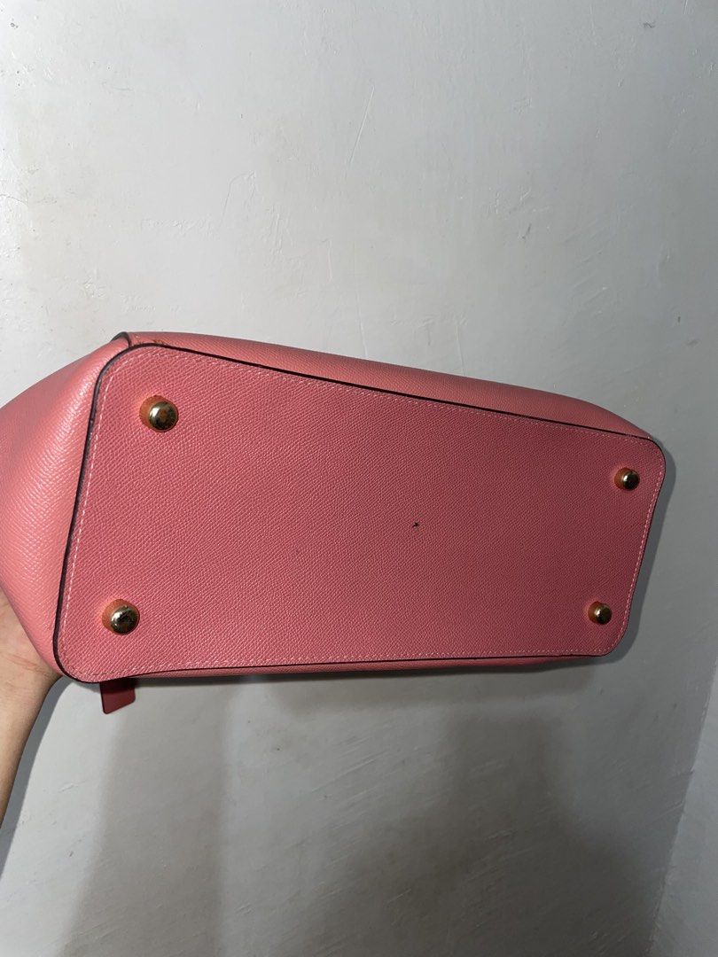 Coach Casey Crossgrain Pink Leather Bag (Category: Luxury Bags & Wallets) located in Manila. Submitted by earlonashow (Listing ID 1440427826, Image 3). Description: - Lovely pink Coach tote bag - Made with textured leather - Main zippered compartment - Interior pockets for organization - Four protective metal feet on the bottom - Interior lining shows some wear - Ideal for everyday use.