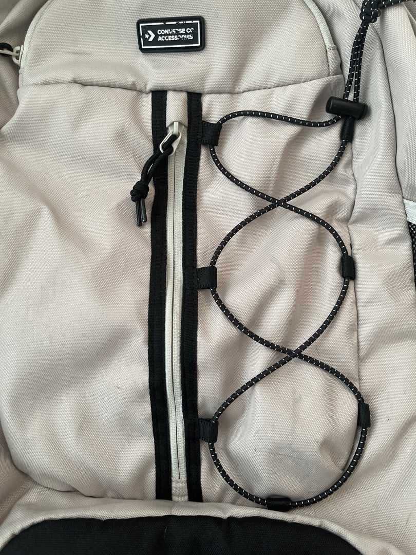 Converse Backpack Beige with Black Accents (Category: Backpacks) located in Quezon City. Submitted by sabrinaxdc (Listing ID 1440407850, Image 3). Description: - Beige Converse backpack - Black trim accents - Mesh side pockets for water bottles or essentials - Elastic bungee cord detail on the front - Adjustable padded straps for maximum comfort - Ample interior space - Ideal for school, work, or everyday adventures.
