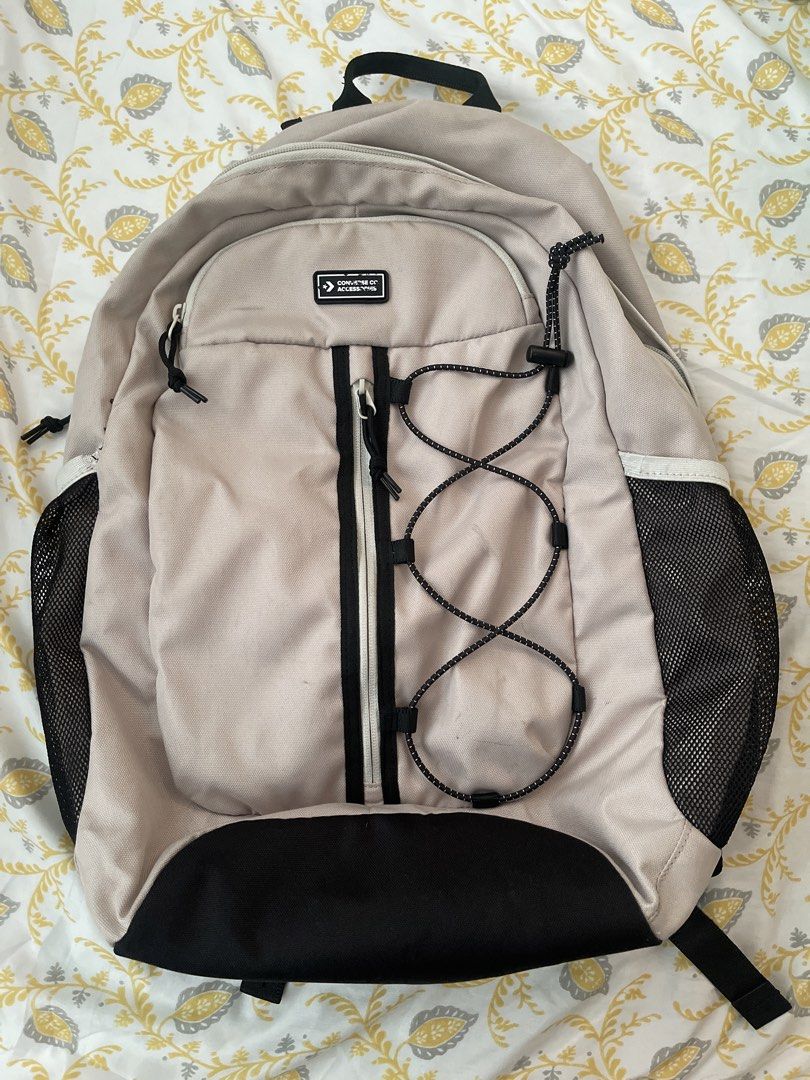 Converse Backpack Beige with Black Accents (Category: Backpacks) located in Quezon City. Submitted by sabrinaxdc (Listing ID 1440407850, Image 1). Description: - Beige Converse backpack - Black trim accents - Mesh side pockets for water bottles or essentials - Elastic bungee cord detail on the front - Adjustable padded straps for maximum comfort - Ample interior space - Ideal for school, work, or everyday adventures.