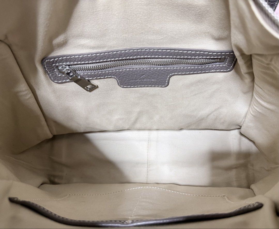 Daniel Hechter Paris Leather Handbag Taupe (Category: Luxury Bags & Wallets) located in Cavite. Submitted by lady_speculator_ph (Listing ID 1440575705, Image 3). Description: - Authentic Daniel Hechter Paris handbag in a stylish taupe color. - Crafted from textured leather with elegant white stitching details. - Secure top zipper closure for your belongings. - Convenient interior zippered pocket for essentials. - Adorable tassel detail on the fro