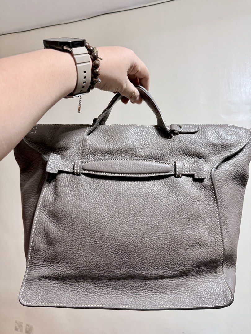 Daniel Hechter Paris Leather Handbag Taupe (Category: Luxury Bags & Wallets) located in Cavite. Submitted by lady_speculator_ph (Listing ID 1440575705, Image 2). Description: - Authentic Daniel Hechter Paris handbag in a stylish taupe color. - Crafted from textured leather with elegant white stitching details. - Secure top zipper closure for your belongings. - Convenient interior zippered pocket for essentials. - Adorable tassel detail on the fro