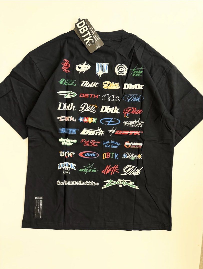 DBTK Black T-shirt with Graphic Print (Category: Tshirts & Polo Shirts ) located in Quezon City. Submitted by hajjyong (Listing ID 1440440529, Image 2). Description: - Classic black DBTK t-shirt - Features a large, multi-logo graphic print on the back - Small DBTK logo detail on the front chest - Comes with original tags are attached - Brand new - with zip lock Payment first basis..